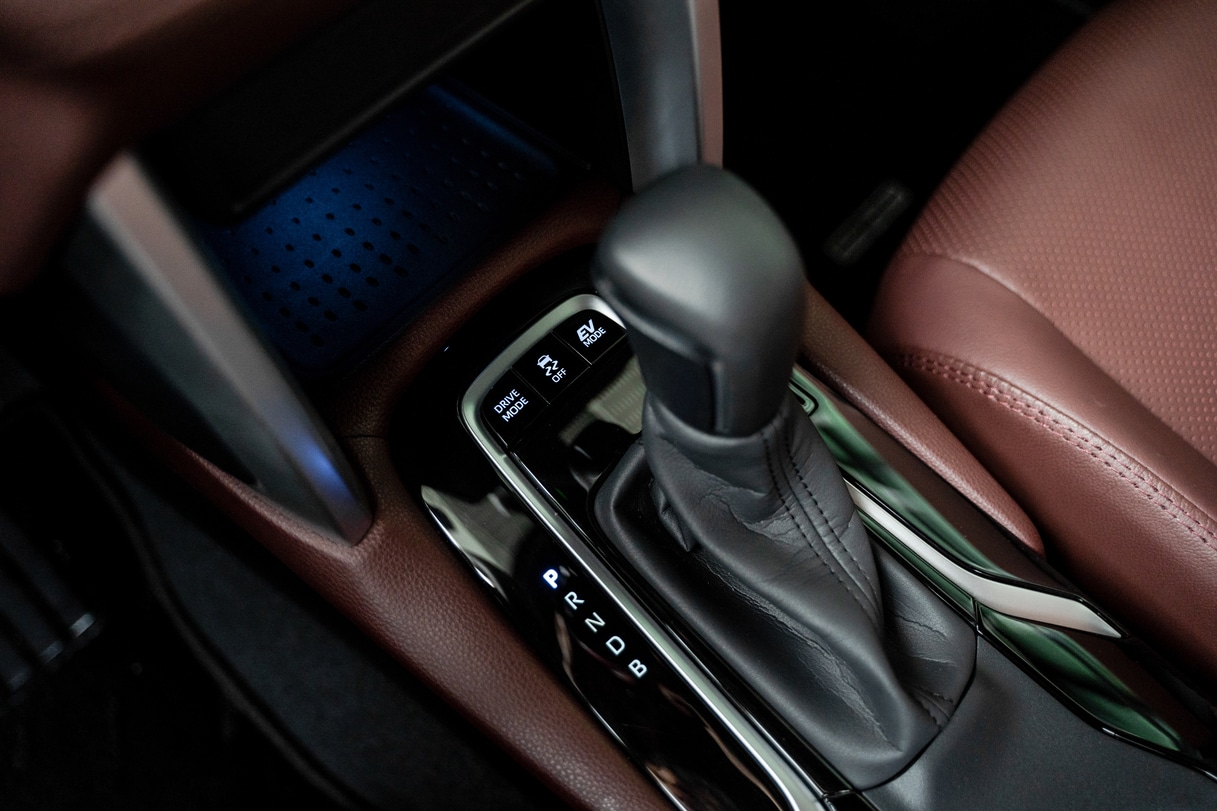 Bàn tay người lái đang chọn chế độ vận hành trên Toyota Cross Hybrid.